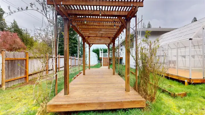 The pergola is the heart of the backyard. It is perfect for your summer furniture and entertaining guests in the back yard. Just to the left of the photo is a gate to Tagholm Rd so you have access to the back yard for RV,s or vehicles etc.