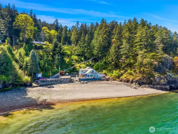 Broad protected beachfront spans the shoreline in front of the bluff home at 1438 Seacrest and 1442 Seacrest on the beach.  1 acre vacant lot is the high bank to the right.
