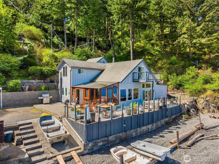 The beach residence at 1442 Seacrest is positioned just 8 feet from the shoreline bulkhead—an irreplaceable siting no longer permitted under current shoreline setback regulations. This rare grandfathered location includes two private mooring buoys & 2nd class tidelands.