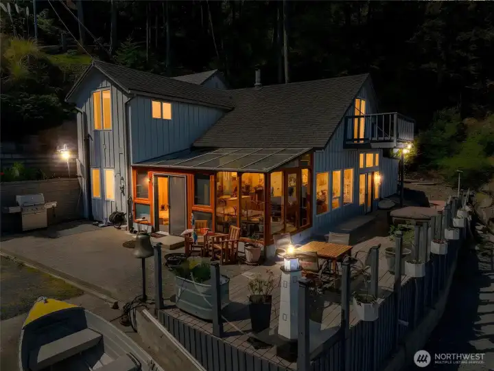 Evening light reflects across protected Hales Passage just steps from the primary residence at 1442 Seacrest, where shoreline placement only 8 feet from the bulkhead creates a true waterfront living experience that cannot be replicated under modern shoreline rules.