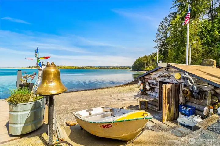 “Gramp’s Log Cabin” anchors the shoreline for these Seacrest Drive homes.  Boat launch area suitable for a 20’ power boat-This charming beachside cookhouse reflects the property’s 70+ year family legacy. A distinctive gathering space for crabbing days, beach fires & waterfront entertaining.