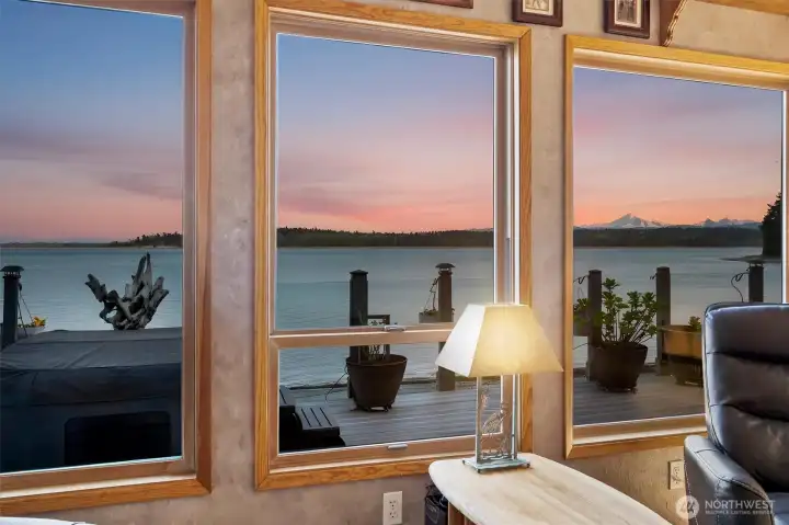 Framed views across Hales Passage to Portage Island & Mt Baker are enjoyed from inside the primary residence at 1442 Seacrest, where the home’s rare placement just 8 feet from the shoreline bulkhead creates a true over-the-water living experience no longer permitted under current shoreline setback regulations. Expansive east-facing windows capture sunrise light, passing marine traffic & year-round wildlife activity from one of the most uniquely positioned waterfront homes on Lummi Island.