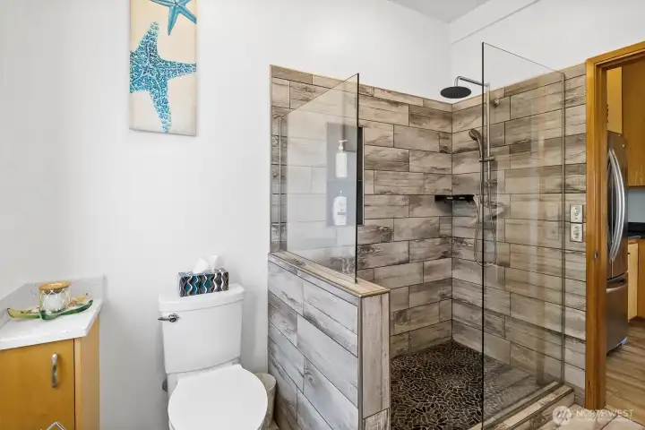 Updated main-level ¾ bath at 1442 Seacrest features a modern tiled walk-in shower & clean contemporary finishes, complementing the home’s primary-suite-on-main layout. Thoughtful updates enhance comfort for everyday waterfront living