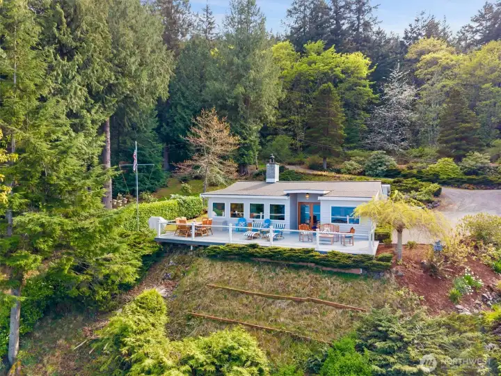 1438 Seacrest. This is the bluff-top home which enjoys a commanding outlook across Hales Passage toward Portage Island, the Cascade Mountains...offering a rare elevated perspective within this legacy multi-parcel waterfront estate.