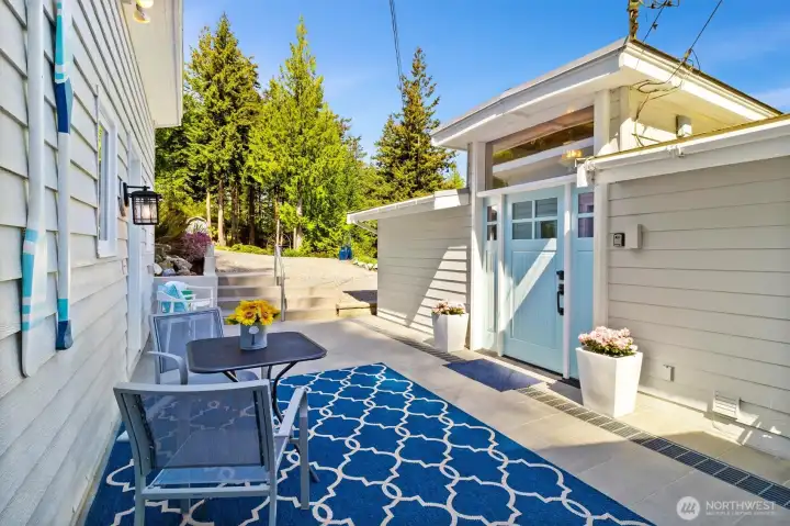Covered entrance to the home on the right, 400 sq feet of tiled patio leads you to a 300 sq ft shop and storage area w/generator.