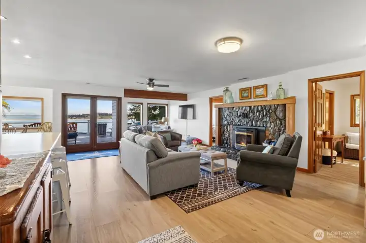 Remodeled great room concept with original fireplace and new flooring