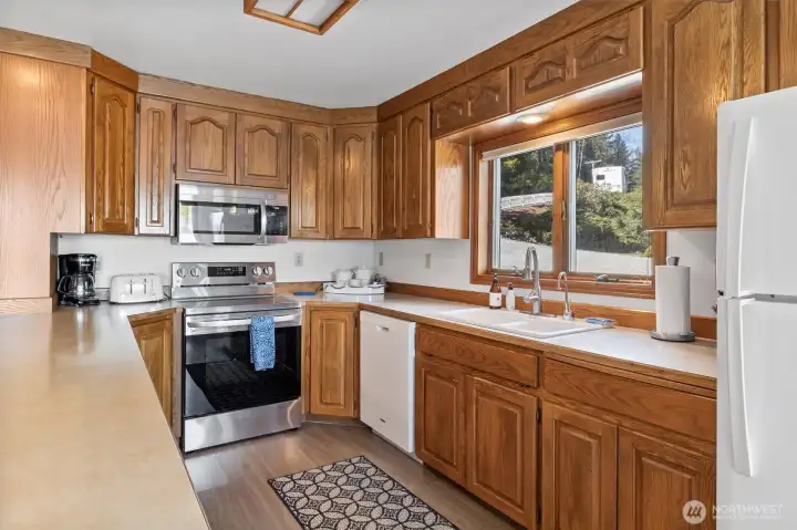 Large kitchen with new range and microwave in 2023