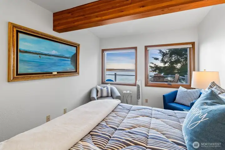 Exposed beam carries into the water facing bedroom overlooking the water.