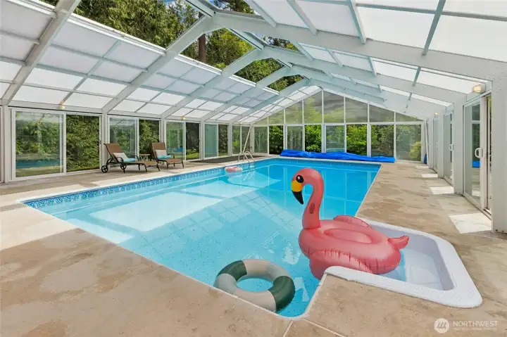 Enclosed pool with retractable roof and 18 sets of sliding doors - perfect for using year round!