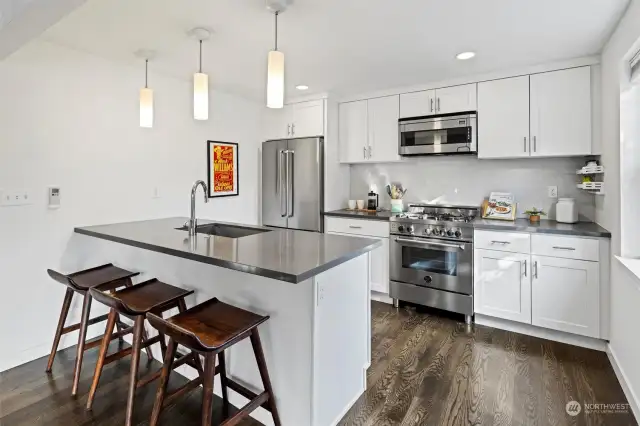 Kitchen has gas range, stainless steel appliances and ample space to sit and counterspace.