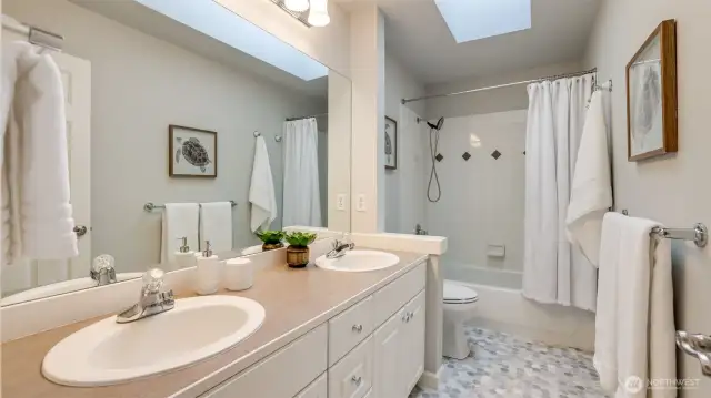 Hall bathroom offers new flooring, dual sinks and skylight