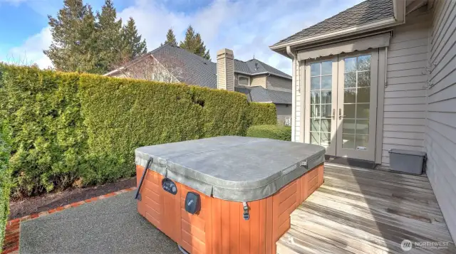 The hot tub is tucked away for privacy yet easily accessible through the French doors.