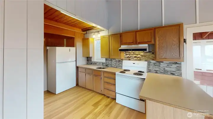 Kitchen by the front door and you walk thru to the bathroom. Photo is digitally altered