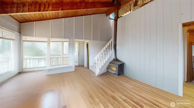 Living room with cozy wood burning fireplace. Photo has been digitally altered.