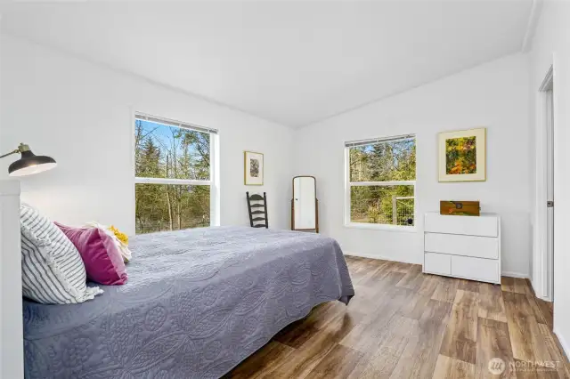 The spacious primary bedroom is filled with natural light and features a walk-in closet and a private ensuite bath.