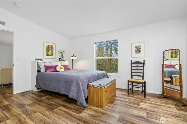 Another view of the spacious primary bedroom, conveniently located next to the sitting area.
