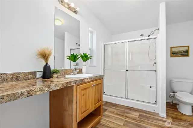 The expansive ensuite bath features a generously sized shower stall for ultimate comfort.