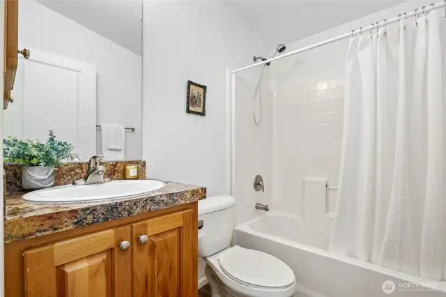 The second bathroom includes a full-size tub for relaxing soaks.