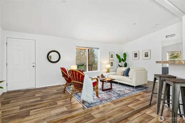 The great room boasts soaring vaulted ceilings, creating a bright and inviting atmosphere.