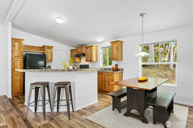Another perspective highlighting the two dining options—bar seating and space for a dining table.