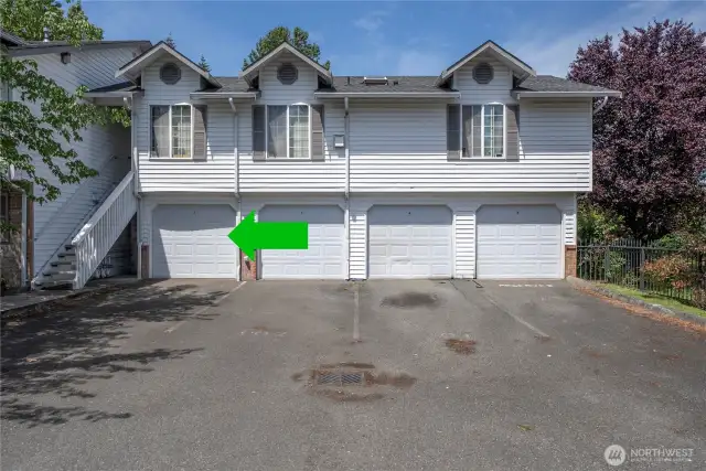 Private garage with additional parking spot in front of garage.