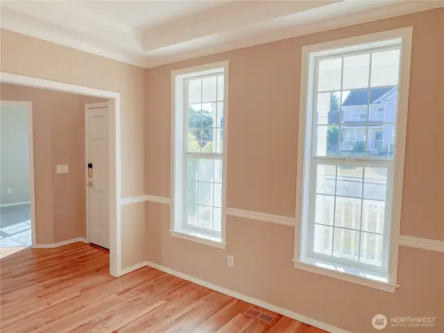 Formal dining/flex room with tray ceiling to the right of the front door.