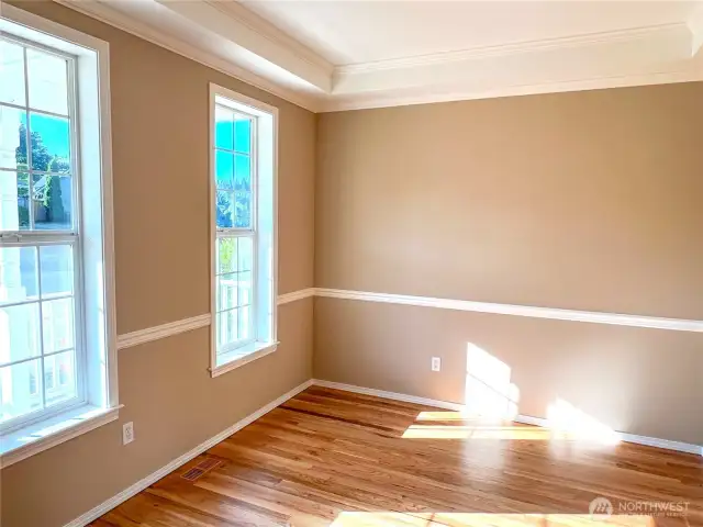 Natural light fills the room, highlighting the beautiful hardwood floor.