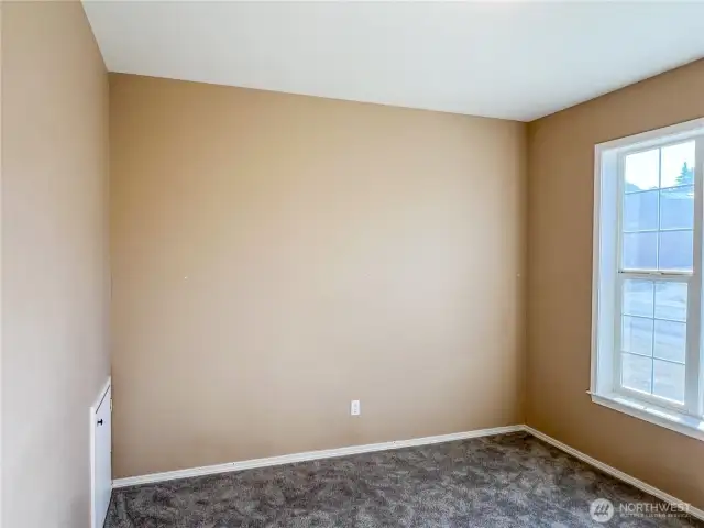 Den/office with under stairwell storage, across the front foyer from the formal dining/flex room.
