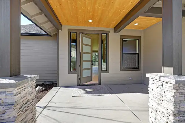 Covered front entry with stone accept posts.