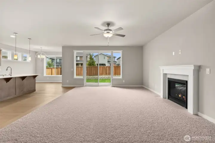 Great room looking back to kitchen and dining room offers fantastic space for entertaining. Large slider door off great room leads to the backyard.