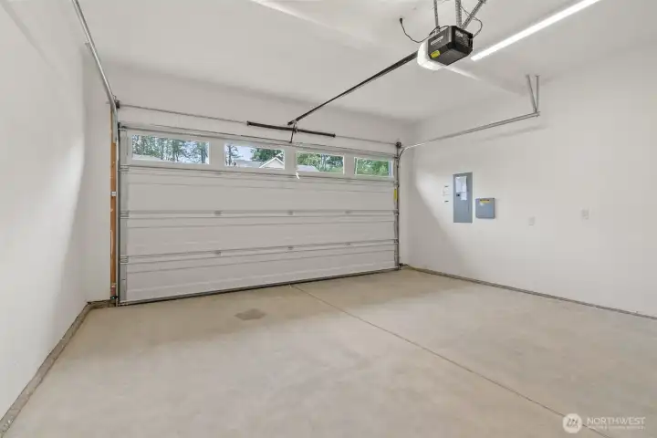 Two car garage with door opener and 2 remotes.  Walls are fully primed for a finished look.