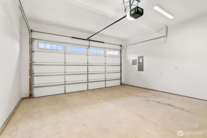 Two car garage with door opener and 2 remotes. Walls are fully primed for a finished look.