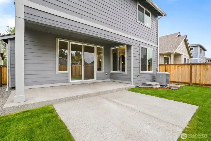 Partially covered back patio, perfect for relaxing or BBQing.
