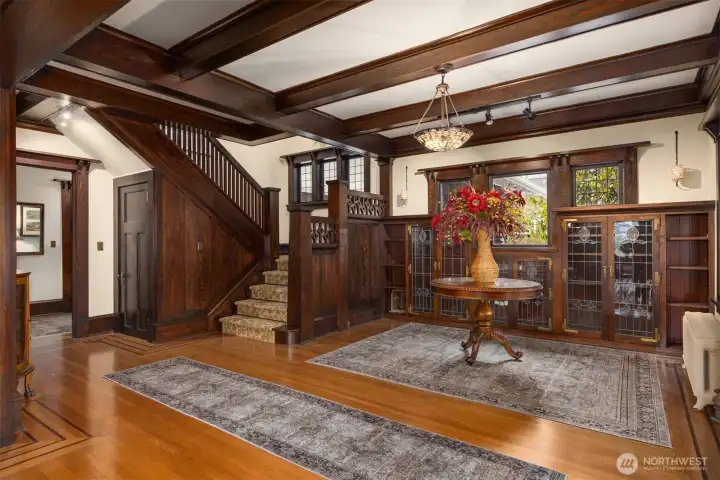 The heart of the home reveals itself in this stunning central hall. A statement staircase, leaded glass built-ins, and handcrafted details speak to a level of craftsmanship rarely found today, creating a sense of permanence, heritage, and quiet grandeur.