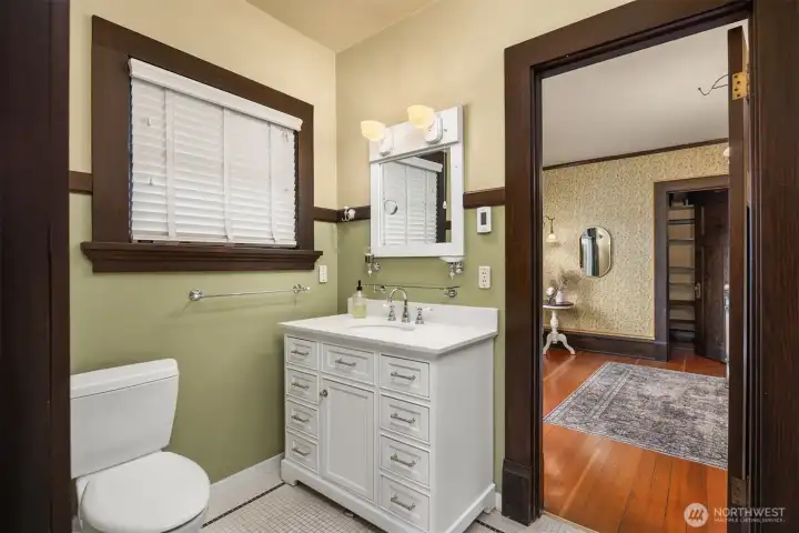 A tastefully updated 3/4 bathroom honors the home’s era with period-appropriate finishes, a classic vanity, and original trim—balancing modern function with timeless design.