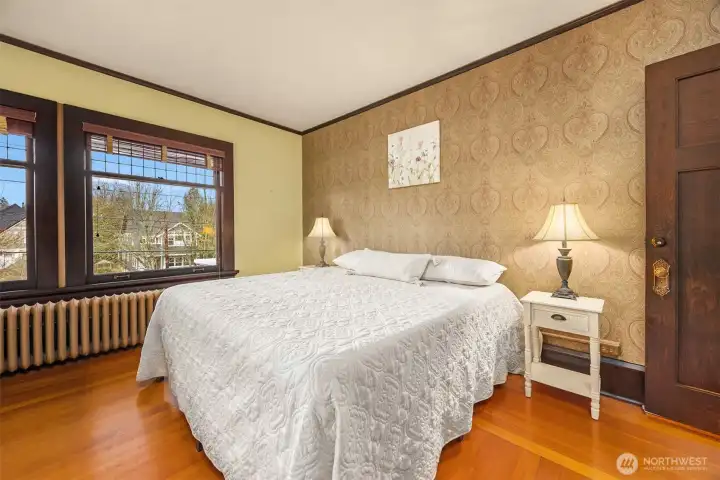 Another generously sized bedroom with walk-in closet continues the theme of authenticity, featuring hardwood floors, classic trim, and abundant natural light—perfect for guests, family, or a home office.