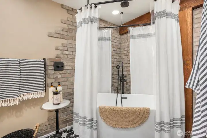 The lower level includes a stunning full bath with custom tile work and a deep soaking tub—blending spa-like comfort with design-forward finishes rarely found in basement spaces. Possibility of a MIL or STR.