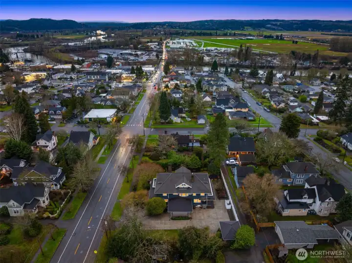 Aerial views highlight the home’s prime position near historic downtown Snohomish, surrounded by established neighborhoods, tree-lined streets, and open valley views beyond — reinforcing both lifestyle and long-term value.