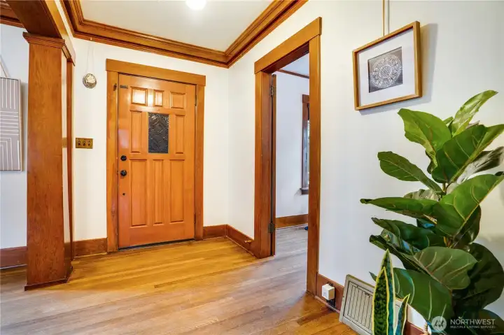Take note of the original millwork and classic columns that define the entryway.