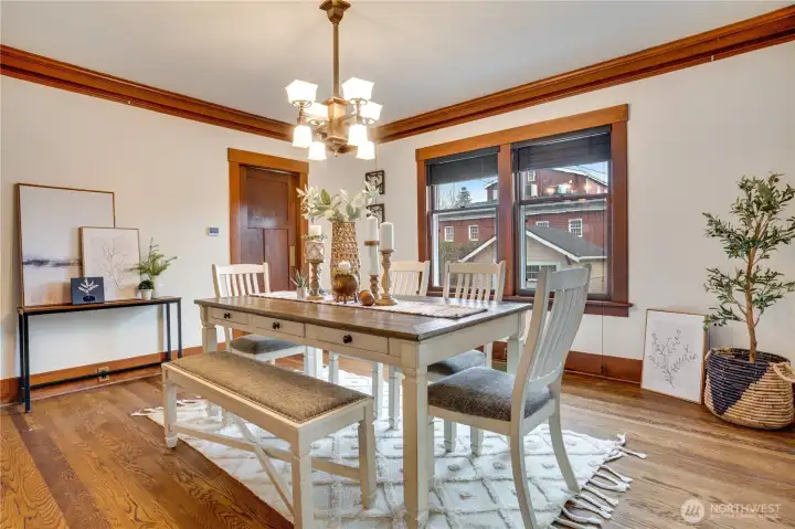 From the dining room, a doorway opens to a small hallway that leads to a three-quarter bathroom and a newly refreshed kitchen.
