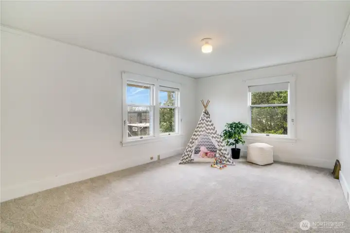 This third bedroom is spacious and bright, with fresh paint and new carpet that make it shine.