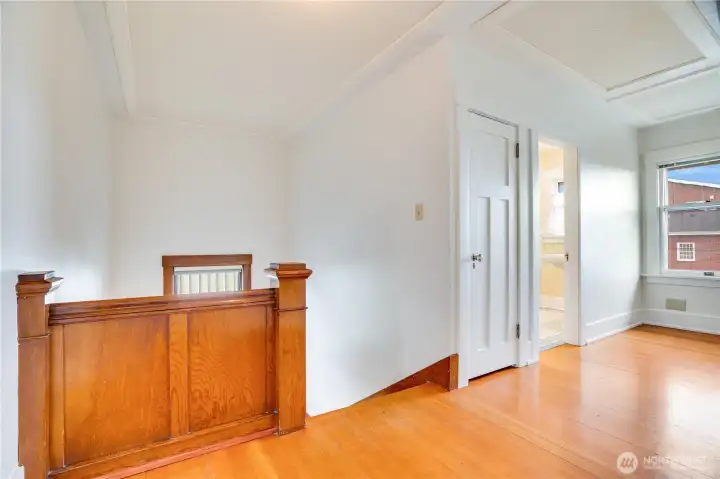 The fresh paint and gleaming fir floors give the upstairs landing a bright, airy feel.