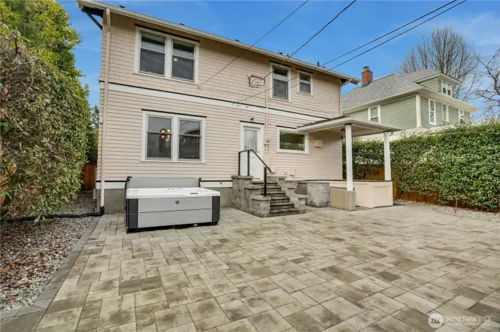 Along with a fresh exterior paint job, the backyard received a top-of-the-line upgrade too! Extensive hardscaping—check out the size of this patio!—plus a new hot tub with self-cleaning features, a built-in refrigerator, and a well-established barbecue area make it a true outdoor haven.