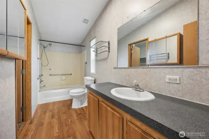 Large master bathroom with new flooring.