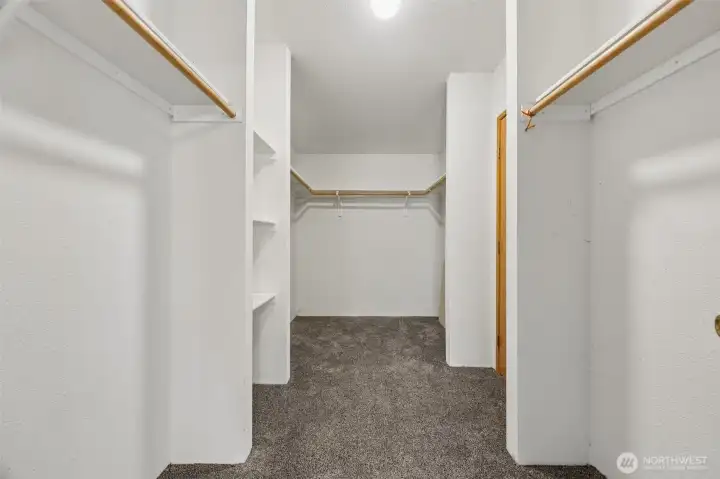 Walk-in closet with additional shelves for added storage.
