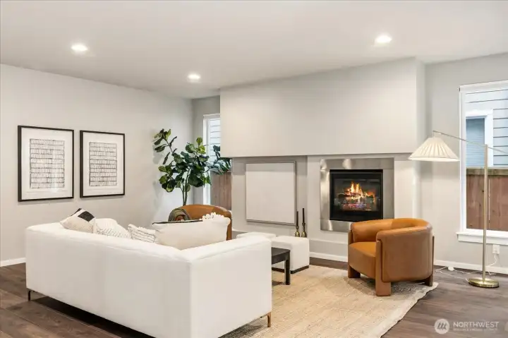 A study in modern architecture, this great room pairs clean lines with inviting warmth, centered around a sleek gas fireplace.