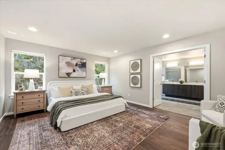 A grand-scale primary retreat with french door entry and serene backyard views.