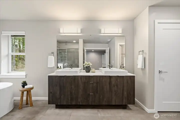 A spa-inspired primary bath, thoughtfully designed as a five-piece retreat with a deep soaking tub and ceiling-mounted rain shower.