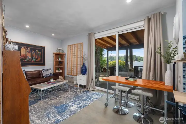 Studio with sliding glass back door leads you to an inviting patio and full lake view.  Great for guests to come and visit or a main floor living space.