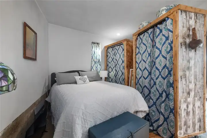 Bedroom in the studio, partition has built in closet system.
